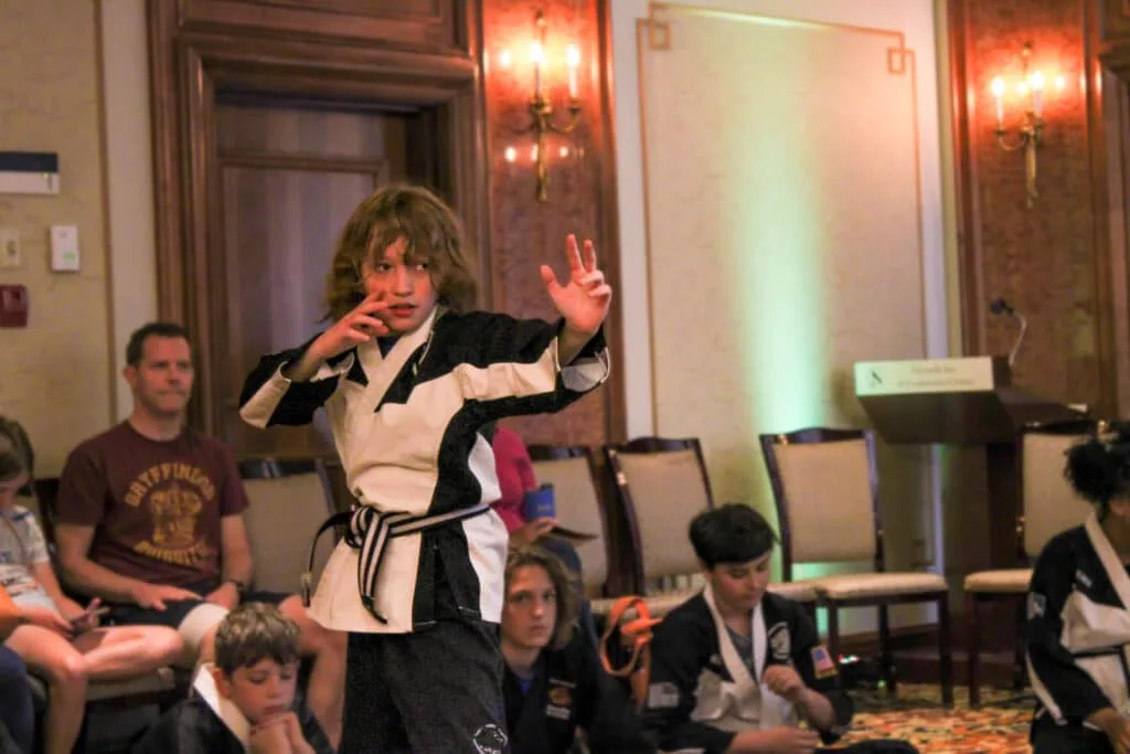 Student practicing focus in martial arts class.