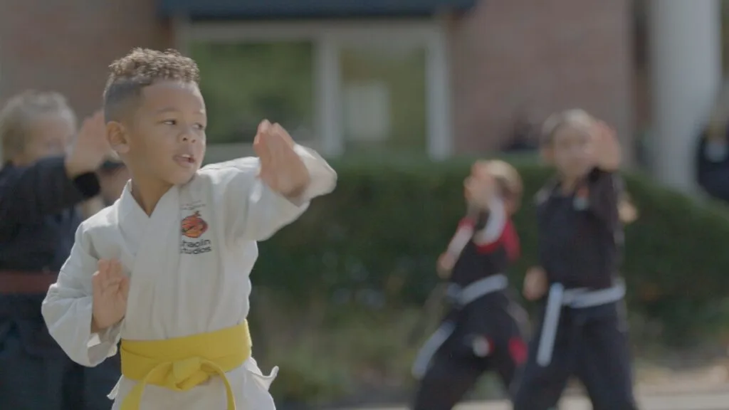 Student practicing martial arts skills with confidence.